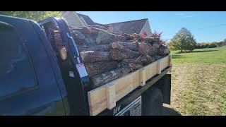 C5 mfg. flatbed dumping firewood.