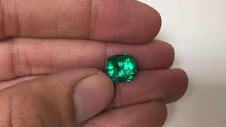 Close look at a bluish green rare cushion cut Colombian emerald 3.93 carats