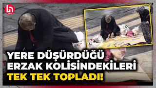 Yoksulluğun en acı görüntüsü! Yere düşürdüğü erzak kolisinde dökülenleri elleriyle tek tek topladı!