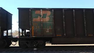 BNSF SD70ACe #8785 \u0026 #9317 \u0026 BNSF ES44AC #6318 lead a northbound empty coal hoppers train .