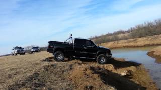 Chevy Lifted 4x4 truck going in mud to an island