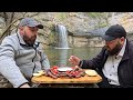 cooking a juicy tomahawk steak by a waterfall outdoor grilling adventure epic food experience