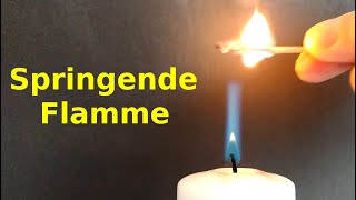 Jumping flame at a candle - igniting wax vapor