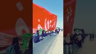 Externally big flag of Imam Hussain (as) being waved on the road to Karbala #Arbaeen