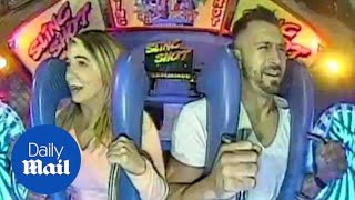 Hilarious moment couple go on fun fair ride 'the slingshot' - Daily Mail