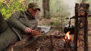 Forest Bushcraft Day Camp with special pot hanger construction and wooden reflective wall