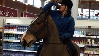 Horse walks into a... supermarket! Woman downs Pepsi after trotting into Tesco on HORSEBACK