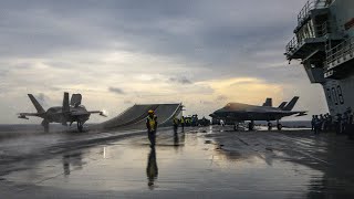 Jets fly from HMS Queen Elizabeth in rainy conditions in the Bay of Bengal