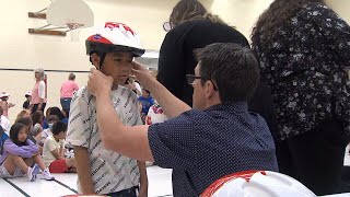 Local lawyers donate bike helmets to students