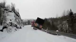 Lorry and tow truck slide off snowy cliff in Norway