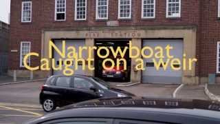 Narrow Boat Stuck in strong current on a weir in Reading.