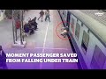 Moment passenger saved from falling under Indian train | Yahoo Australia