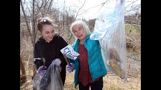 Natalie and Hazel Litt pick up trash, garbage at Grand Marais Drain