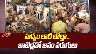 Visakhapatnam : రోడ్డుపై మద్యం లారీ బోల్తా.. మందు బాటిళ్లకోసం ఎగబడ్డ జనం | NTV