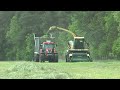 zetor crystal 170 hd tractor working side by side with krone big x on grasland in germany