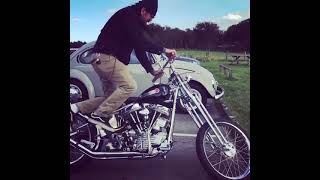 Kick starting classic Harley-Davidson chopper motorcycle