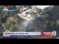 Firefighters battling blaze beneath Hollywood Hills homes