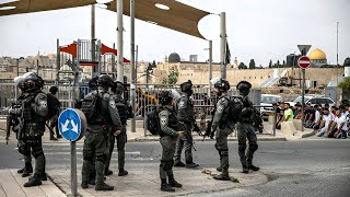 Pilgrims wait at the Qalandiya check post to enter the Al Aqsa Mosque