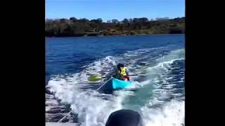 Getting towed by boat in kayak