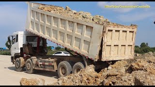 Dump trucks unloading soil build road construction