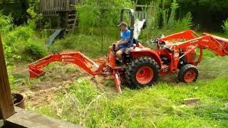 Kubota tractor filling a hole