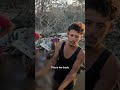 Palestinian man holds up remains of a 12-year-old child after Israeli strike