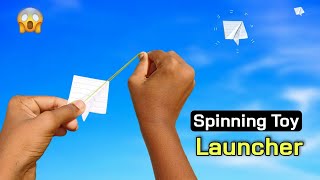 notebook paper flying spinner, rubber band spinning toy, make flying spiner toy, notebook launcher