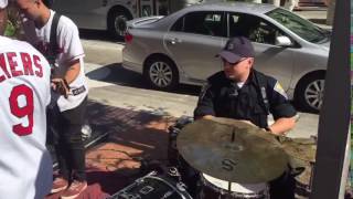 Police officer jams with sidewalk band at RNC