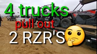 Four trucks pull out trailer with 2 RZR'S from the sand AT PISMO DUNES dunas