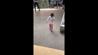 Little Adorable Girl Going Down a Slide Lands on Her Butt Hard