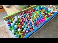 make a water marble run course using a wiggle device and lots of colorful balls. rainbow course