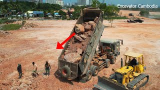 Be careful When Dump Truck Unloading Stone And Bulldozer Working Pushing Big Stone