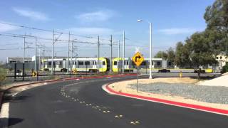 P3010 Kinkisharyo train cars moving out of maintenance shed.