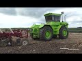 big tractors plowing lots of great tractors on work in the field