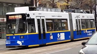 An impeccable Kumamoto City Tram fleet departing Hanabatcho (near Kumamoto Castle)