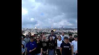 Tourists on Mt. of Olives,Jerusalem reciting Psalm 112:6 in Hebrew : Pray for the peace of Jerusalem