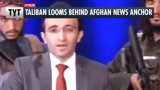 Gun-Wielding Taliban Looms Behind News Anchor