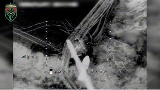 A Ukraine R-18 drone drops explosive munitions on Russian armor during a raid last night