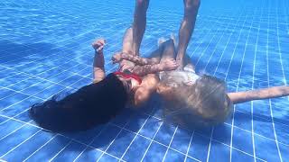 3 girls breath hold unerwater at the bottom of swimming pool (experimental)