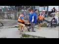 Rescuers take the body of a drowned woman from the beach