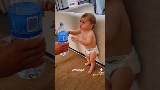 Thirsty baby drinking like Dad