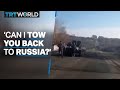 Ukrainian man offers to tow back stalled Russian tank