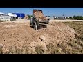 technique. processing use dump trucks 5t with komatsu d31px dozer pouring land to fill flooded soil