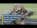 British and German troops try out each other's weapons on tank hunting exercise