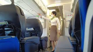 Beautiful Vietnamese Air Hostess doing Safety Announcement