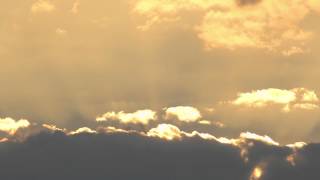 Morning sunrise time lapse with red sky and moving clouds with sunbeams