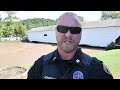 crowd gathers at covered bridge during flood