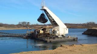 Swimmexcavator digging gravel