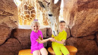 Diana and Roma feed the animals at the Emirates Park Zoo
