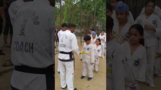 Tying Yellow Belt, this honour by coach to students. 28 June 22 P (1)
